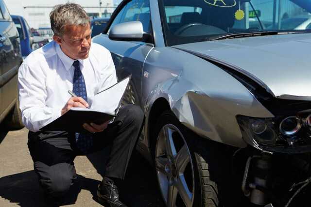 man assessing dent repair